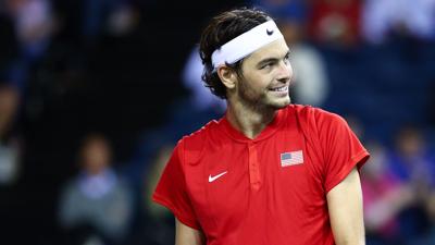 taylor fritz looks off into the distance smiling