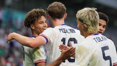 USMNT players celebrate after scoring a goal.