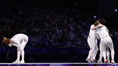 Italian women's epee team celebrate next to French Auriane Mallo